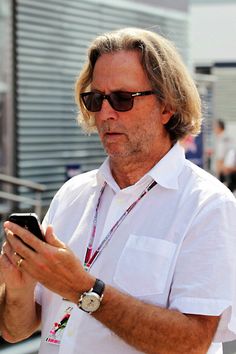 a man wearing sunglasses looking at his cell phone