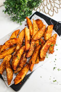 baked potato wedges on a tray with parsley