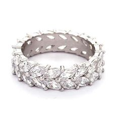 a white gold ring with rows of diamonds on the sides and leaves in the middle