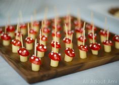 there are many red and white candies with toothpicks on them