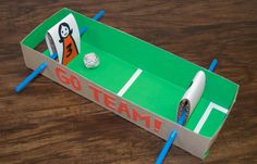 a cardboard box that has some pens and paper on it with the word go team