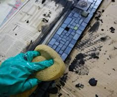 a blue gloved hand is on top of a broken keyboard