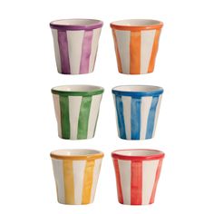 four different colored cups with stripes on them