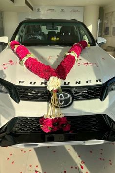 a white car with flowers on the hood