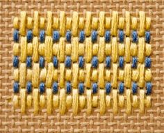 a close up view of a woven material with blue and yellow stitching on it