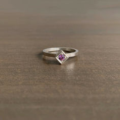 A vivacious pink sapphire is nestled in a sweet silver cube. 

Sterling silver 
Sapphire, 3mm (1/8") in diameter 
Cube is 5mm x 5mm (3/16" x 3/16") Pink Sapphire Sterling Silver Ring, Heart-shaped Pink Sapphire Jewelry As Gift, Newport Ri, Pink Sapphire, Newport, Sapphire, Fine Jewelry, Sterling Silver, Ring