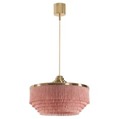 a pink and gold chandelier hanging from a light fixture with fringes on it