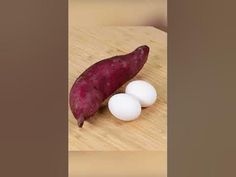 an egg and potato on a cutting board with the skin still attached to it's end