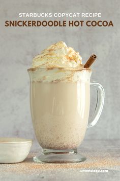 a cup filled with whipped cream and topped with cinnamon