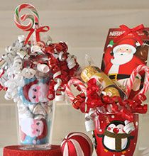 a vase filled with candy and candies on top of a red stand next to a candy cane