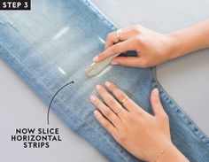 a woman using a nail file to cut off her jeans