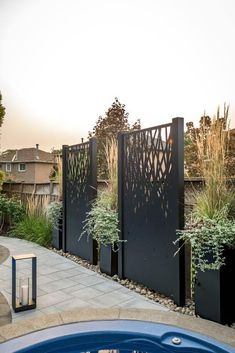 an outdoor hot tub in the middle of a yard with plants growing out of it