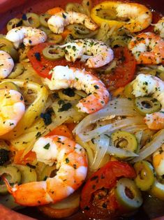 a bowl filled with shrimp and vegetables on top of a table