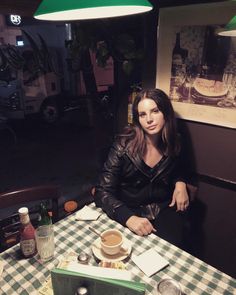 a woman sitting at a table with food in front of her