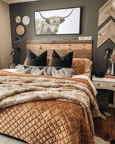 a bedroom with a bed, nightstands and pictures hanging on the wall above it