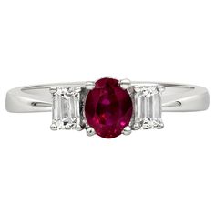 A beautiful three-stone engagement ring style, showcasing a 0.79 carat oval cut ruby, set on a four prong basket. Flanked by emerald cut diamonds weighing 0.41 carat total. Made with 18K white gold. Size 6.5 US, resizable upon request. Roman Malakov is a custom house, specializing in creating anything you can imagine. If you would like to receive a special quote on a custom piece, please message or call us. Oval Red Ruby Ring With Three Stones, Luxury Oval Three-stone Ruby Ring, Classic Red Three Stone Diamond Ring, Classic Three Stone Ruby Ring With Diamonds, Classic Three-stone Ruby Ring, Classic Three Stone Ruby Ring, Oval Three Stone Ruby Ring With Diamonds, Oval Ruby Ring With Three Diamonds, Formal White Gold Ruby Ring With Three Stones