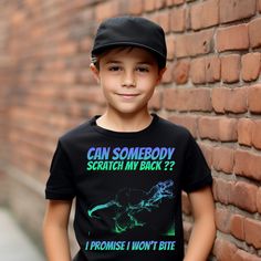 "Bring a burst of color and a lot of laughter into your child's wardrobe with our Unisex Kids' T-Shirt featuring a hand-drawn crazy neon color pattern T-Rex dinosaur. The playful text reads, \"Can somebody scratch my back? I promise I won't bite.\" 🦖🌈 This vibrant and whimsical design will capture the imagination and bring joy to kids of all ages. Who could resist helping out a T-Rex in need? 🎨 The T-shirt showcases a unique and artistic interpretation of the mighty T-Rex, making it an ideal Playful Short Sleeve Tops With Graffiti Print, Black Dinosaur Print Short Sleeve T-shirt, Black Short Sleeve T-shirt With Dinosaur Print, Playful Black T-shirt With Screen Print, Funny Black T-shirt With Dinosaur Print, Scratch My Back, T Rex Dinosaur, Let The Fun Begin, Whimsical Design