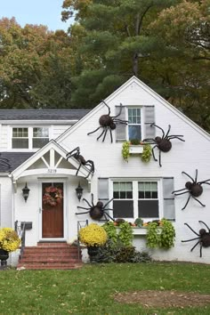 a white house decorated for halloween with spider decorations