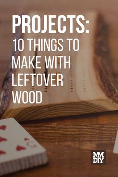 an open book sitting on top of a wooden table next to playing cards and dice