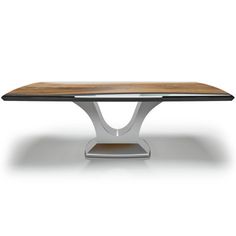 a wooden table sitting on top of a white floor next to a black and silver base