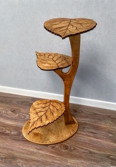 a small wooden table sitting on top of a hard wood floor next to a wall