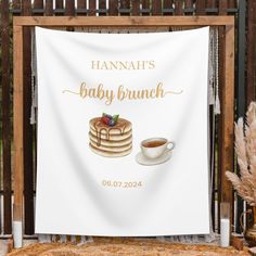 a banner that says hannah's baby brunch next to a cup of coffee