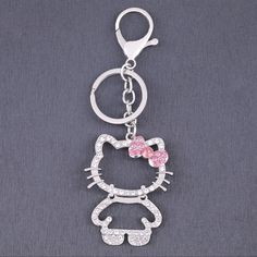 a hello kitty keychain with pink bow and crystal stones on the bottom part