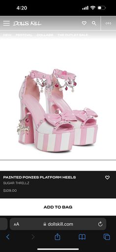 a pair of pink and white high heel shoes with bows on the heels are being displayed