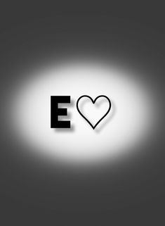 the word e is written in black and white with a heart shaped shadow on it