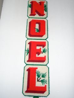 three cross stitch banners with the words noel spelled out in red and green