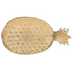 a gold fish shaped tray with leaves on the front and back side, sitting on a white background