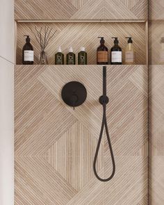 the shower head is connected to two shelves with soaps and lotions