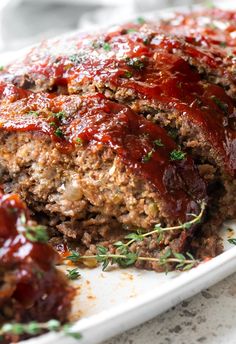 meatloaf with sauce and herbs on a plate