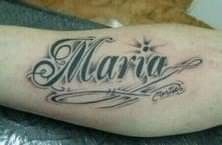 a person with a tattoo on their arm that says marra in cursive writing