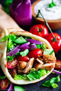 chicken, lettuce and tomato pita wraps with ranch dip in the background