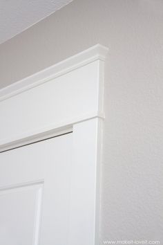 the corner of a room with a white door