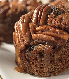 two pieces of chocolate cake with pecans on top