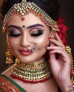 a woman with makeup and jewelry on her face