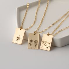 "Select up to three flowers to create a one of a kind Combined Rectangle Birth Flower Necklace just for you. It's great for layering, a wonderful minimalist piece, perfect gift for your wife, girlfriend, Mother's Day gift or simply to treat yourself! Engraved and hand assembled with care and love, it comes in 14k gold fill, rose gold fill, or sterling silver. HOW - TO - ORDER 1. Select your options from the drop down menu see photo for birth flower options 2. Chain length options are 16\", 18\" Rectangular Birth Flower Necklace As Gift, Rectangular Necklace For Mother's Day Gift, Gold Rectangular Birth Flower Jewelry, Gold Rectangular Jewelry With Birth Flower, Delicate Gold Rectangular Jewelry, Delicate Rectangular Gold Jewelry, Engraved Rectangular Necklace For Mom, Engraved Rectangular Jewelry For Mom, Engraved Rectangular Jewelry Gift For Mom