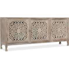 an ornate carved sideboard with three doors and four drawers, in whitewashed wood