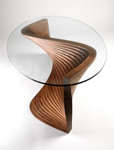 a glass and wood table with an unusual design on the top that is shaped like a wave