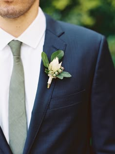 a man in a suit with a boutonniere on his lapel