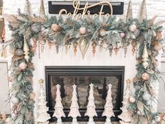 a fireplace decorated with christmas trees and ornaments