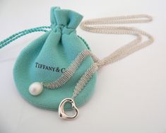 Overview:Offered for sale is a wonderful and gorgeous Tiffany Open Heart & Pearl Mesh Wrap necklace. Definitely a Tiffany piece that you will get your money's value for. It works perfectly with pretty much any attire your put on, AND adds a nice feminine touch to it. It is a wonderful necklace that fits a lifestyle on the go -- the necklace can be worn to pretty much any occasion! It is simple, elegant, and classic all rolled into one necklace. The necklace works with a crisp V neck shirt, a pre Elegant Formal Necklaces For Gifts, Elegant Formal Necklace For Gifts, Luxury Heart-shaped Necklaces For Evening, Luxury Heart Shaped Necklace For Evening, Luxury Heart-shaped Necklace For Evening, Elegant Heart Pendant Necklace As Gift, Elegant Necklace With Heart Charm For Gift Season, Heart Pearl Necklace, Pearl Necklace Pendant