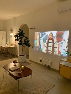 a living room filled with furniture and a flat screen tv mounted to the side of a wall