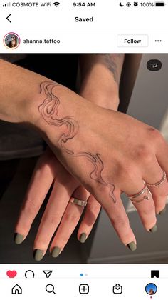 two hands holding each other with tattoos on them