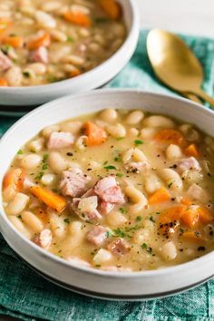 two white bowls filled with ham and bean soup