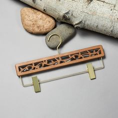 a piece of wood and metal sitting on top of a table next to some rocks