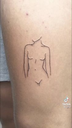 the outline of a woman's body is shown in black ink on her thigh