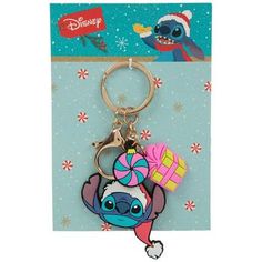 a keychain with a cartoon character holding a present on it's back